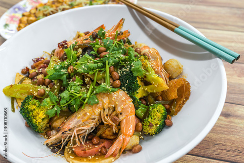 Mala Xiang Guo (stir-fry pot). China, Chongqing Sichuan Spicy Fragrant Pot. Oily, spicy, and numbing Chinese sauce which consists of peppercorn, chili pepper and various spices simmered with oil. photo