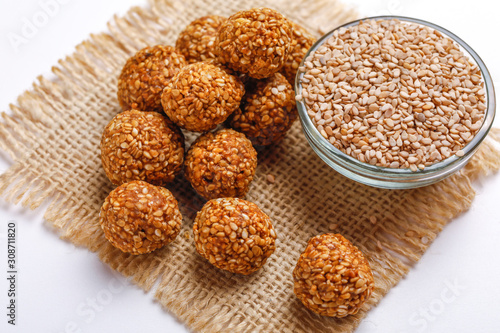 Til Gul OR Sweet Sesame Laddu for Indian festival Makar Sankranti over white background  photo