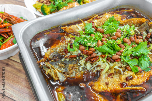 Sichuan Grilled Fish in red spicy oil. Authentic China Chinese Szechuan Chongqing food on table.