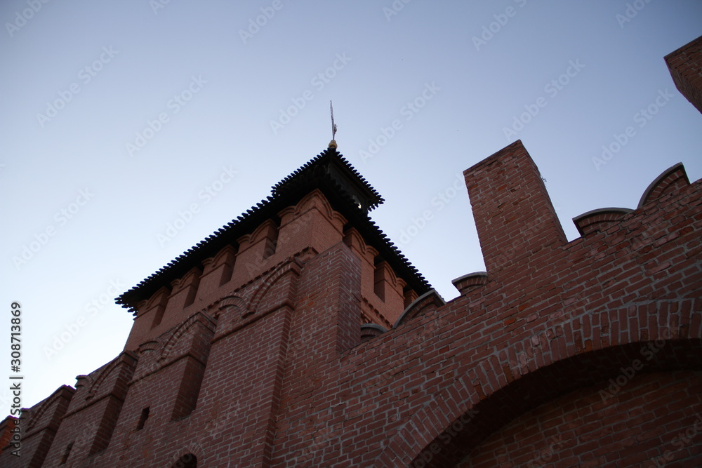 Fototapeta premium One of the towers of the Tula Kremlin Russia. Bottom view. Close-up of the old brick guard tower of 1146. Architectural landscape