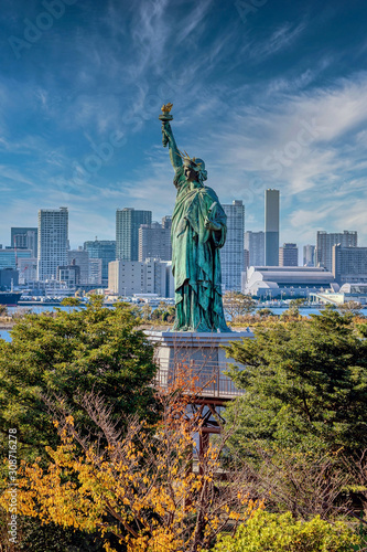 Liberty statue replica in Odaiba, vith a view of Tokyo and the Rainbow Bridge photo