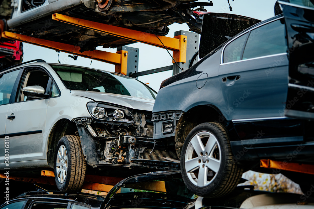 Damaged cars waiting in a scrapyard to be recycled or used for spare parts