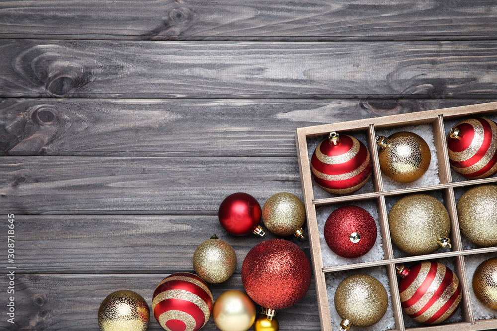 Christmas baubles in box on wooden table