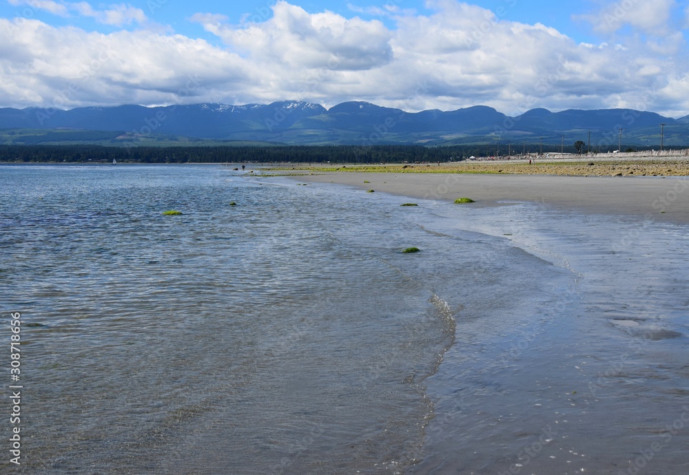 landscape during low tide at Goose Spit Park beach, Comox Vancouver Island, BC Canada; view to the West
