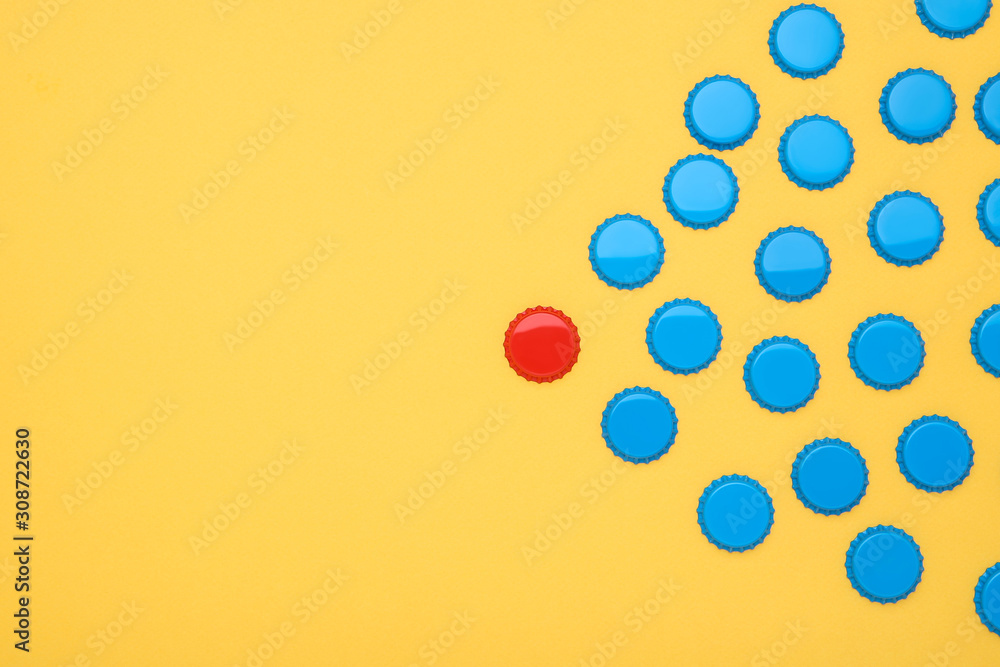 Fototapeta premium Bottle caps leader on yellow background