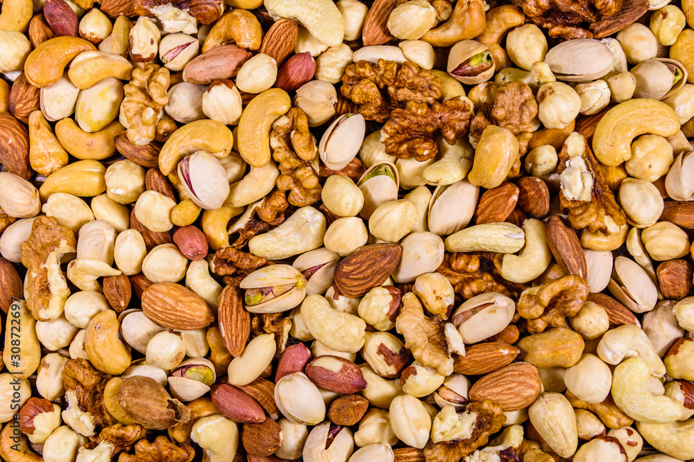 Background of the various nuts (almond, cashew, hazelnut, pistachio, walnut). Vegetarian meal. Healthy eating concept Background of the various nuts (almond, cashew, hazelnut, pistachio, walnut). Vegetarian meal. Healthy eating concept