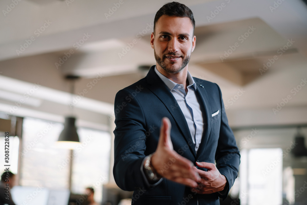 Fototapeta premium Businessman gives a hand for handshaking 