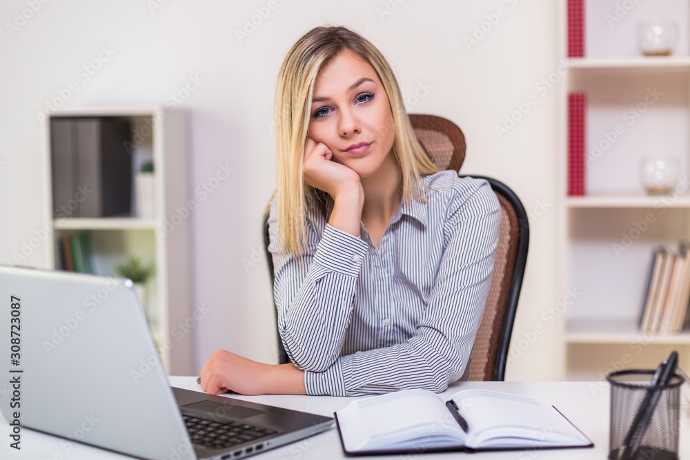 Angry businesswoman sitting in her office and working. Angry businesswoman sitting in her office and working.