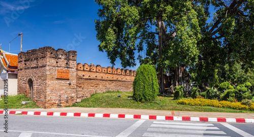 Tha Phae Gate Chiang Mai old town city and street ancient wall at moat (Chiang Mai Gate) is a major tourist attraction in Chiang Mai Northern Thailand.blue sky