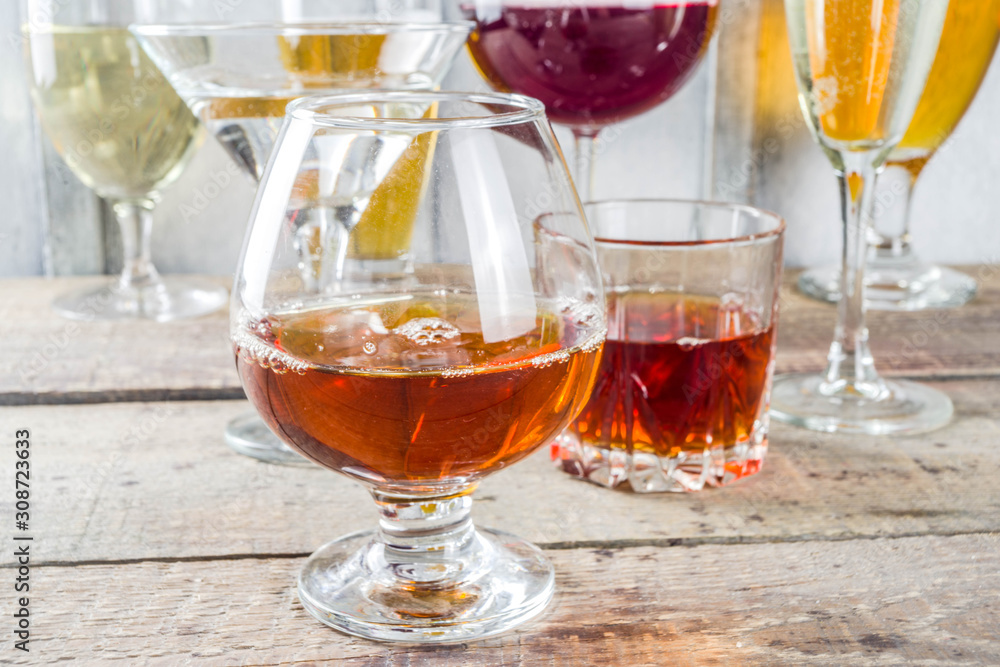 Selection of different alcoholic drinks - beer, red white wine, martini, champagne, cognac, whiskey in various glasses Selection of different alcoholic drinks - beer, red white wine, martini, champagne, cognac, whiskey in various glasses