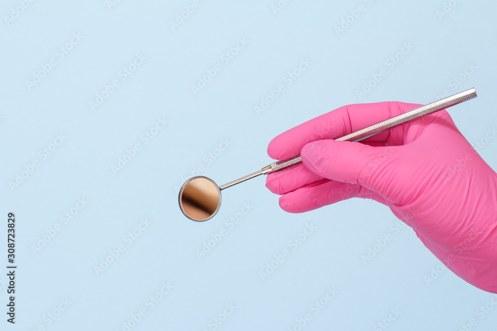 Dentist's hand in glove with mouth mirror. Dentist's hand in glove with mouth mirror.
