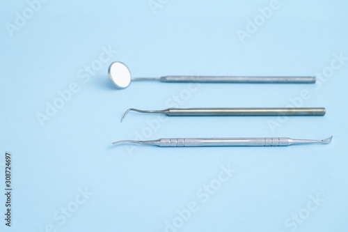 Closeup of dental equipmet laying on blue background