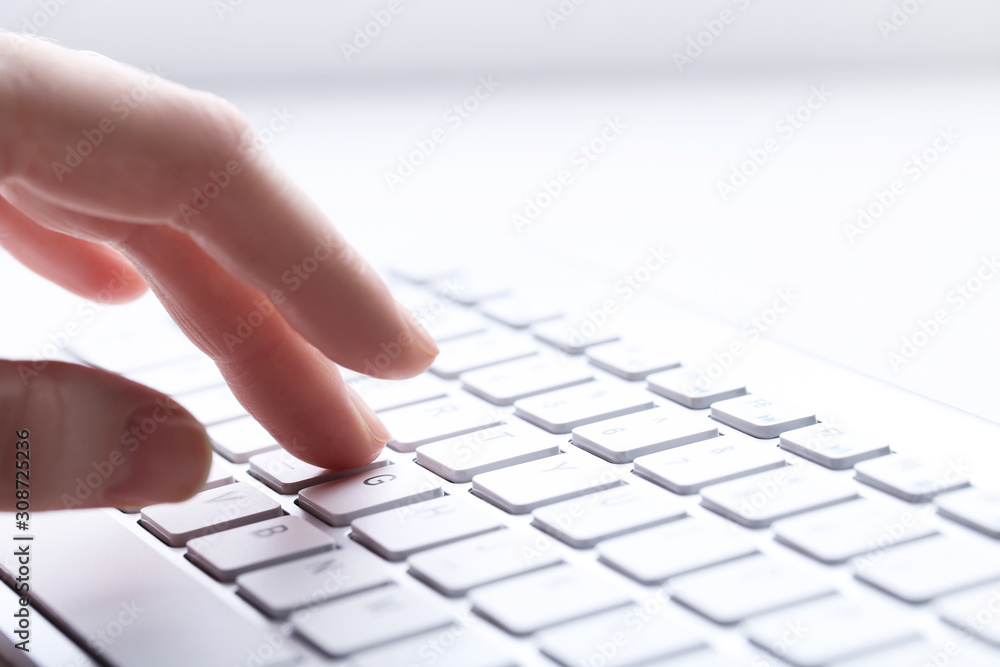 Female hand typing on computer keyboard Female hand typing on computer keyboard