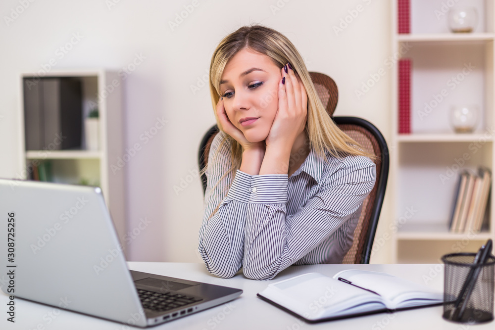 Sad businesswoman sitting in her office and working. Sad businesswoman sitting in her office and working.