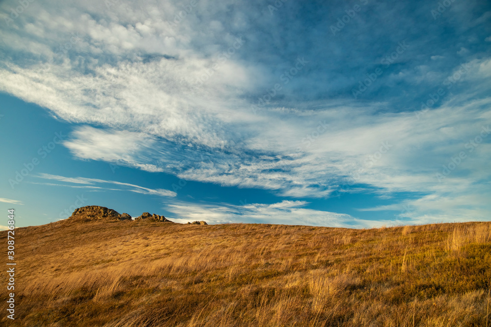autumn time yellow grass highland meadow of mountain ridge scenic landscape nature view with rock and vivid colorful cloudy blue sky moody weather autumn time yellow grass highland meadow of mountain ridge scenic landscape nature view with rock and vivid colorful cloudy blue sky moody weather