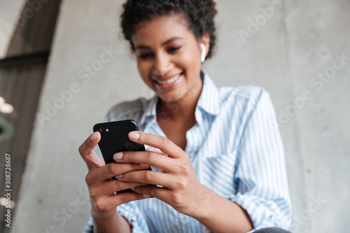 Smiling attractive young african woman wearing shirt