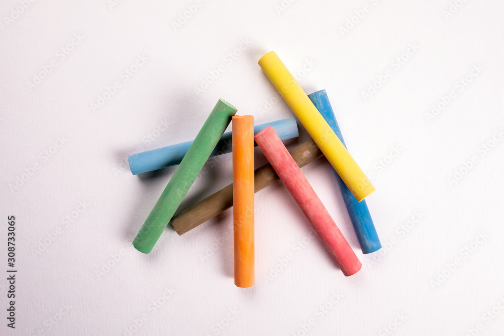 Close up of multicolor chalk on white