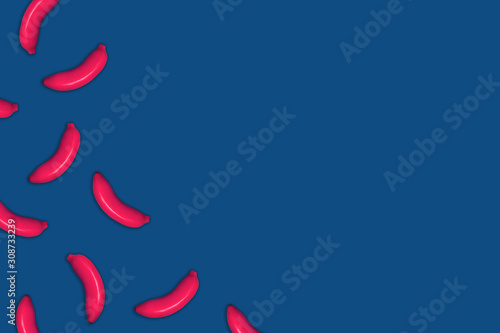 Food pattern of painted pink bananas on classic blue background.