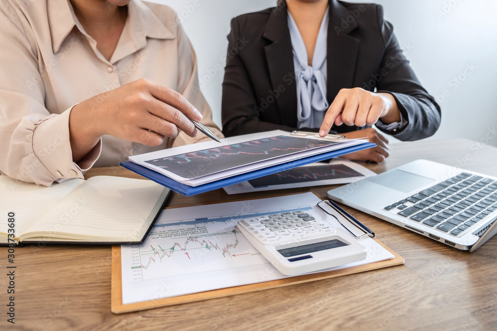 Businesswoman investor on meeting having planning and analyzing of partner cooperation in investment trading marketing project and pointing on the data presented and deal a stock exchange to profit Businesswoman investor on meeting having planning and analyzing of partner cooperation in investment trading marketing project and pointing on the data presented and deal a stock exchange to profit