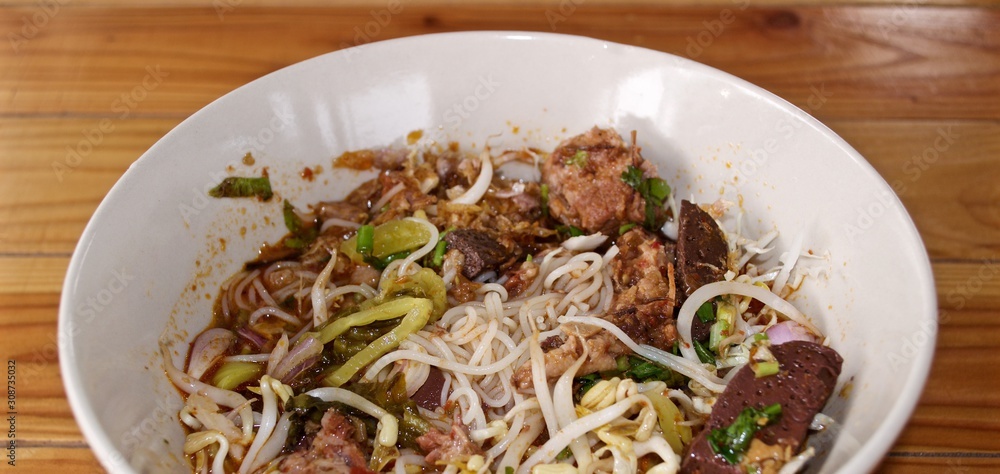 Rice noodle with spicy curry sauce, thai food called : khanom jeen nam ngeiw. Rice noodle with spicy curry sauce, thai food called : khanom jeen nam ngeiw.