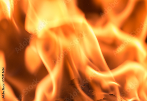 Fire flame burning glowing on black dark background, hot heat energy fuel fire motion pattern abstract texture.