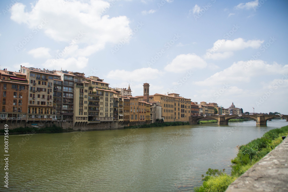 View over a bridge on Arno river at day. Florence, Tuscany, Italy.