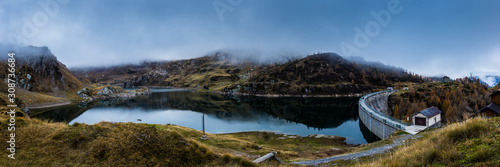 panoramic view of a dam lake in mountain in a cludy day