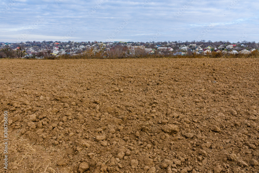 Plowed field at autumn. City Uman on a background. Ukraine Plowed field at autumn. City Uman on a background. Ukraine