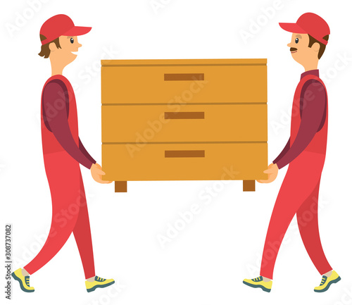 Two male delivery workers wearing red uniform and caps carrying wooden brown chest of drawers isolated on white. Furniture banner vector illustration