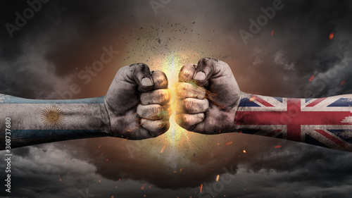 Argentina vs UK. Fists with flags. Battle of two countries on sky.  © JustLife