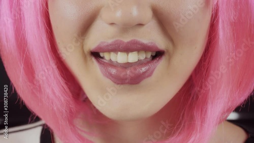 Girl with the lips of the devil. Young beautiful girl with pink hair. A new trend in cosmetology