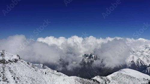 Beautiful clouds above the snowy mountain photo