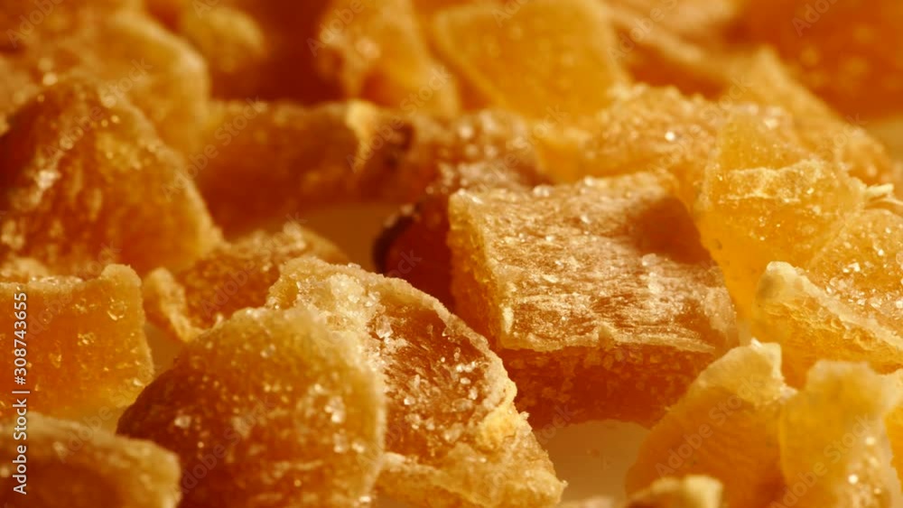 Close up heap of crystallized candied ginger pieces rotating. Yummy snack, better alternative to candy Close up heap of crystallized candied ginger pieces rotating. Yummy snack, better alternative to candy