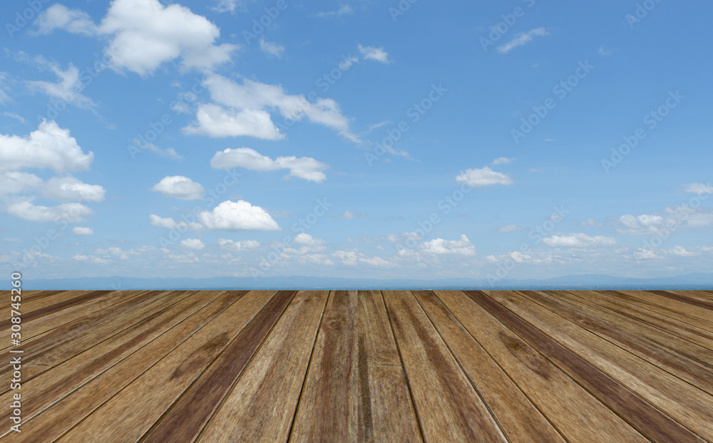 Perspective wooden board empty table top over blue sky with cloudy . Can be used for montage or display your products. Perspective wooden board empty table top over blue sky with cloudy . Can be used for montage or display your products.