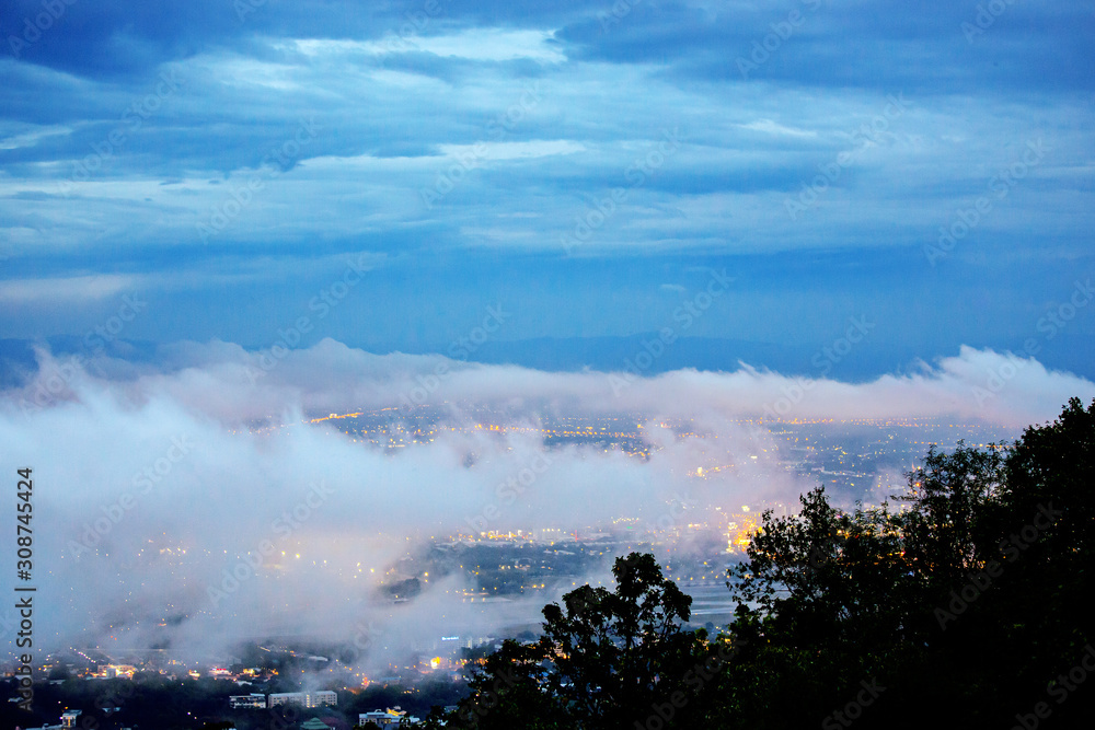 Scenery on top view of  Chiang Mai City on landscape Doi Suthep moutain in twilight sky with misty cloud