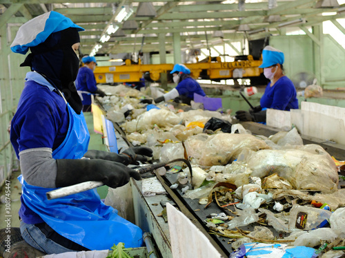 LAMPANGPROVINCE, THAILAND-DECEMBER 7 2016, Women in sepate line collect the plastic and metallic waste from household in waste disposal factory. Recyclable waste in dump site