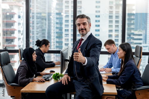 Success boss smiling and thumbs up in front of active teammate or colleague. Success team work concept