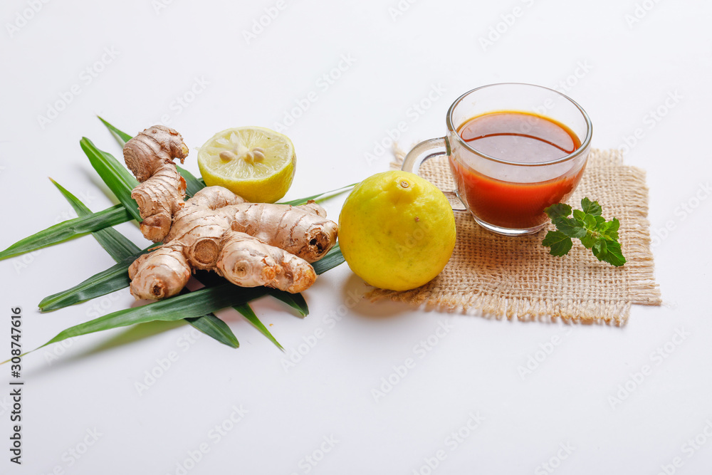 Black tea with lemon and ginger over white background Black tea with lemon and ginger over white background