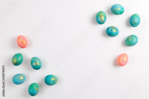 Happy easter card. Stylish minimalistic composition of turquoise with gold easter eggs on a white background. Flat lay, top view, copy space.
