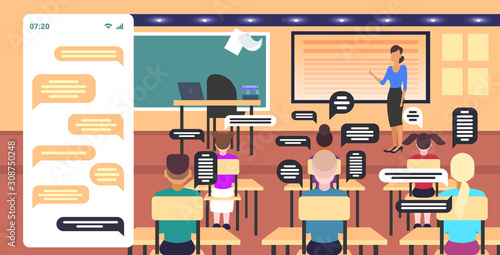 pupils using smartphones mobile chatting app social network chat bubble communication concept mix race schoolchildren sitting at desks modern classroom interior smartphone screen rear view horizontal