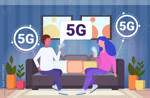 couple using smartphones 5G online communication wireless systems connection fifth innovative internet generation man woman sitting on couch modern living room interior full length horizontal vector
