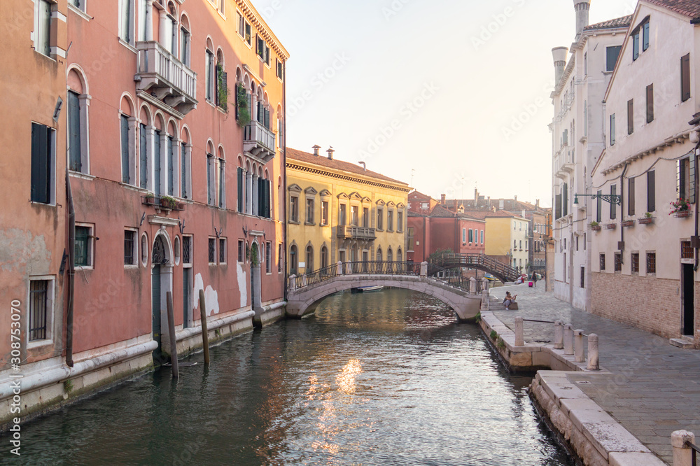 Venice, Italy. Old houses and low bridges over the canal on the street