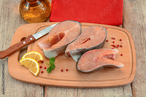 raw salmon steak on a wooden table