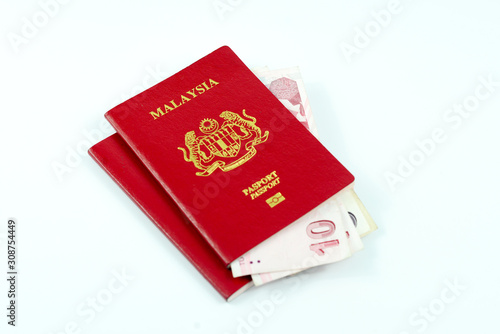 A passport and few korean bank notes isolated on white background. Travel concept.