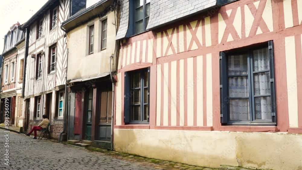 HONFLEUR, FRANCE - APRIL 08, 2018: view of empty beautiful street with old traditional houses at the center of Honfleur, Normandy, France HONFLEUR, FRANCE - APRIL 08, 2018: view of empty beautiful street with old traditional houses at the center of Honfleur, Normandy, France