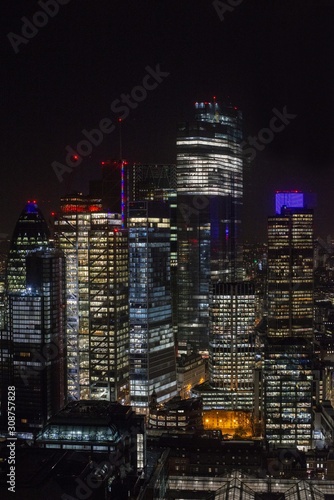 Vertical picture of modern skyscrapers with lights under a night sky in London, the Broadgate tower photo