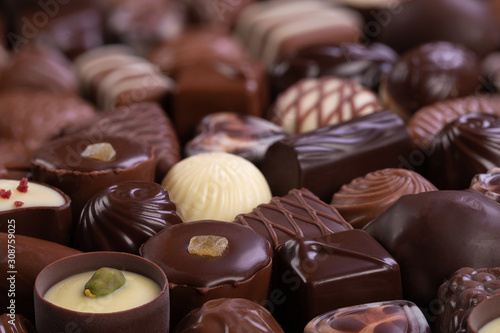 chocolate candies with various fillings, sweet food background.