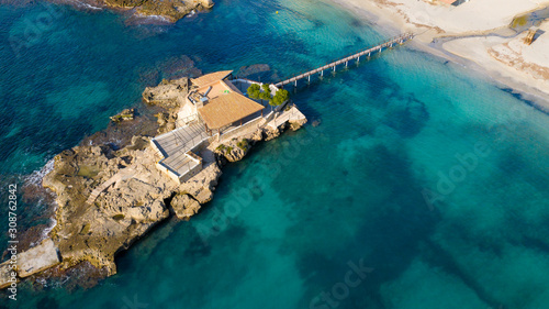 island with a wooden bridge in the Bay of Paguera, Majorca Spain