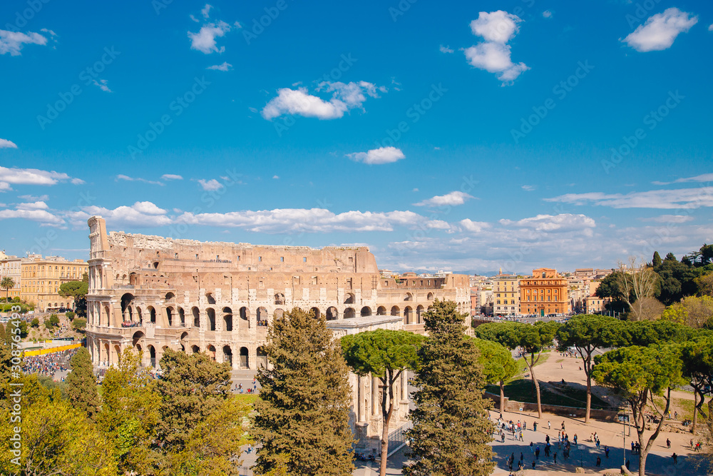 City panorama Rome, Italy Colosseum or Coliseum ancient ruins background blue sky with clouds