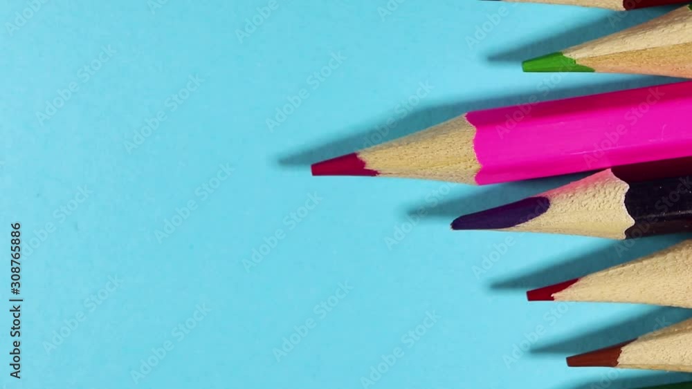 rotation of colored pencils on a blue background. Drawing and learning